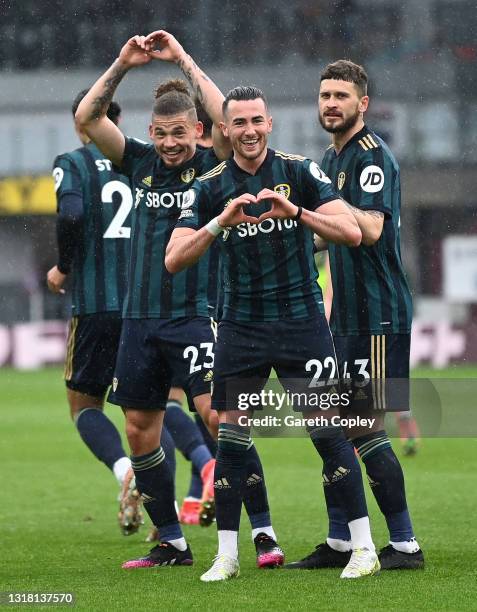 Jack Harrison of Leeds United celebrates with team mates Kalvin Phillips and Mateusz Klich after scoring their side's second goal during the Premier...