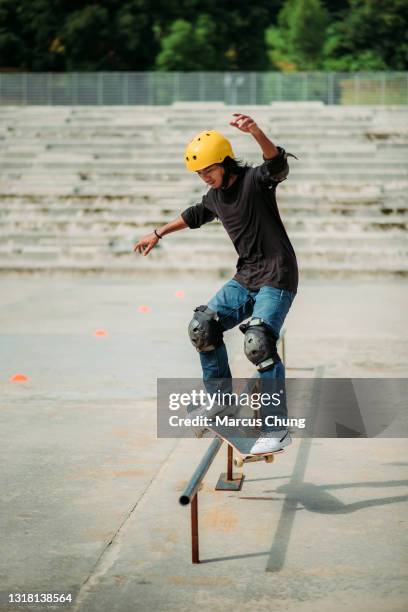 asian male skateboarding in a skate park - skateboarder stock pictures, royalty-free photos & images