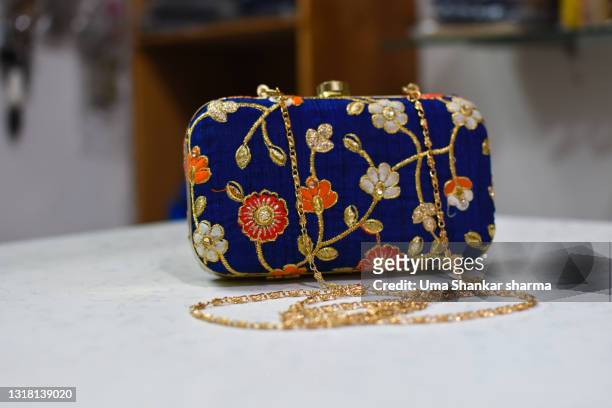 close up shot of designer fashionable ladies handbag clutch, party wear purse with embroidery and fine gold thread work. - clutch bag foto e immagini stock