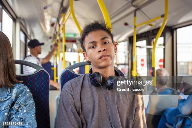 teenage boy while traveling in bus - serious teenager boy stock pictures, royalty-free photos & images