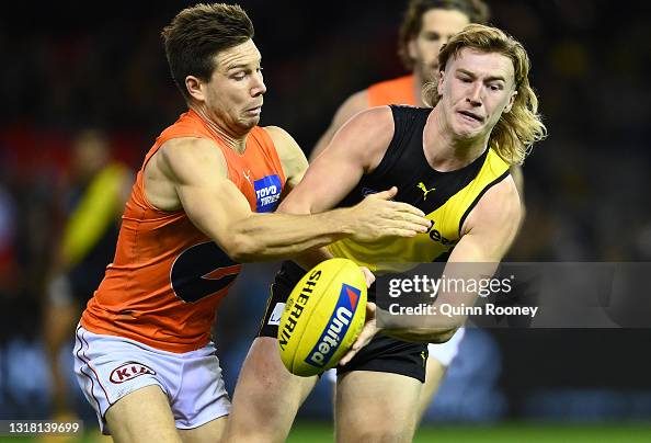 Hugo Ralphsmith Hugo Ralphsmith of the Tigers handballs whilst being tackled by Toby ...