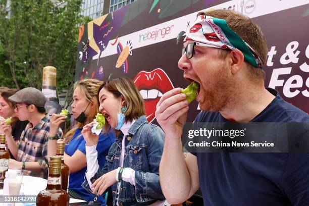 Contestants participate in a chilli eating contest during 2021 Hot & Spicy Festival at Instreet Galleria Mall on May 15, 2021 in Beijing, China.