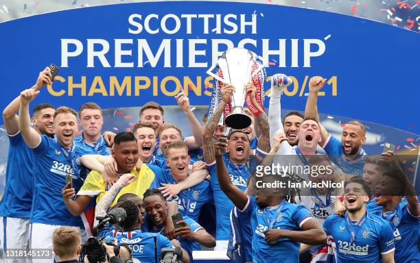 James Tavernier of Rangers lifts the Scottish Premiership Trophy in celebration with team mates following the Scottish Premiership match between...
