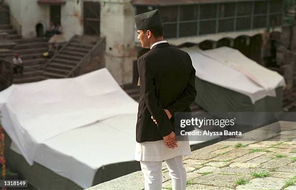 Royal Palace Officer watches the preparation of the cremation site of the Nepalese royal family June 2, 2001 at the Pashupati Nath Araya Ghat complex...