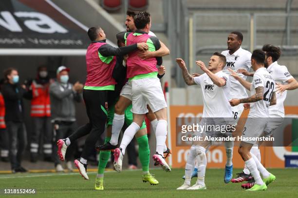 Rani Khedira of FC Augsburg celebrates with team mates after scoring their side's first goal during the Bundesliga match between FC Augsburg and SV...
