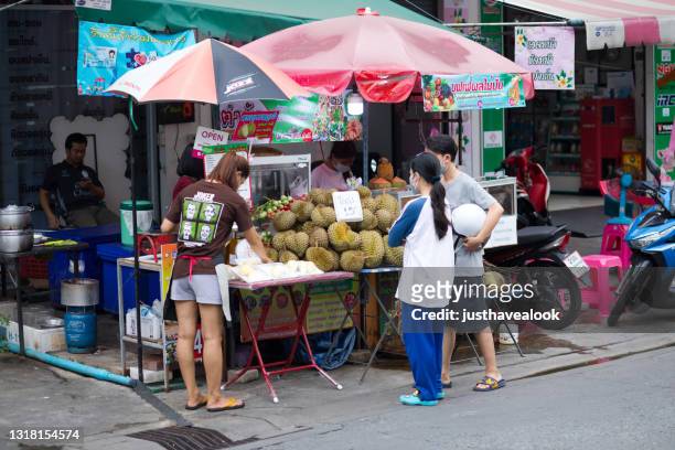 young thai people buying durian fruits - durian stock pictures, royalty-free photos & images