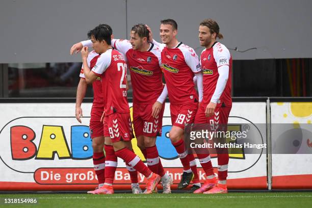Christian Guenter of Sport-Club Freiburg celebrates with team mates after scoring their side's second goal during the Bundesliga match between...
