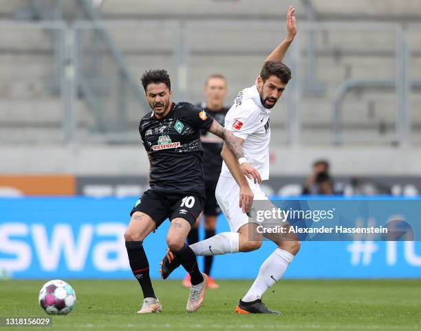 Leonardo Bittencourt of Werder Bremen and Rani Khedira of Augsburg battle for the ball during the Bundesliga match between FC Augsburg and SV Werder...