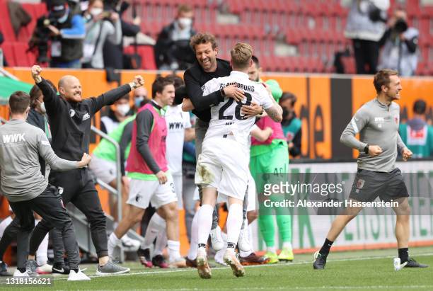 Markus Weinzierl, Head Coach of FC Augsburg celebrates victory with Andre Hahn of FC Augsburg following the Bundesliga match between FC Augsburg and...
