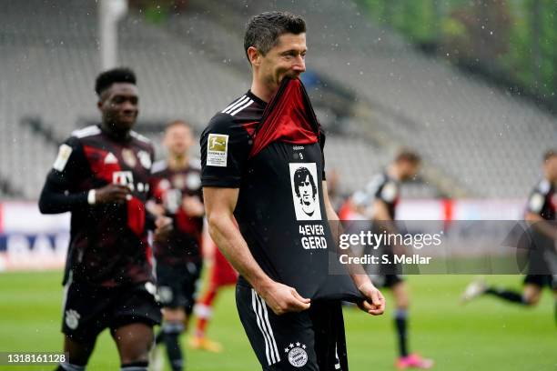 Robert Lewandowski of FC Bayern Muenchen celebrates after scoring their side's first goal from the penalty spot scoring his 40th league goal,...