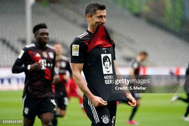 Robert Lewandowski of FC Bayern Muenchen celebrates after scoring their side's first goal from the penalty spot scoring his 40th league goal,...