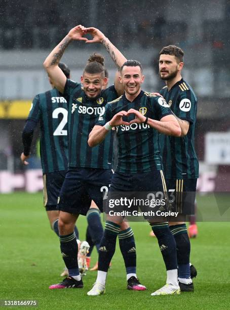Jack Harrison of Leeds United celebrates with team mates Kalvin Phillips and Mateusz Klich after scoring their side's second goal during the Premier...