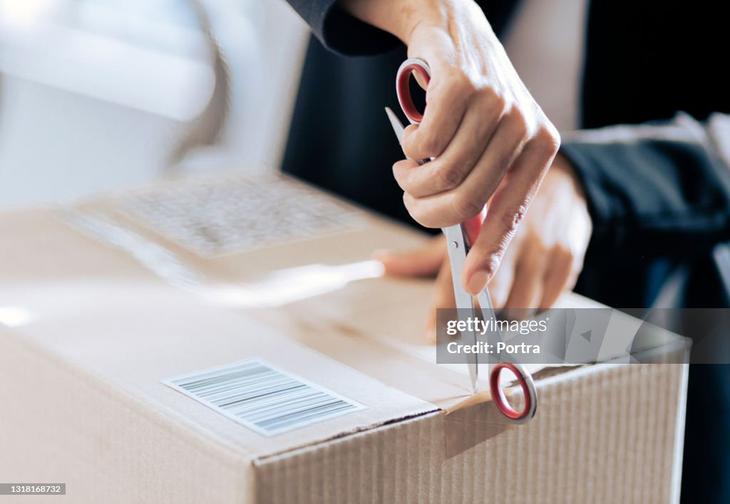 Close-up of a woman opening her courier parcel