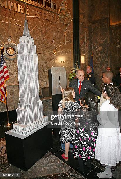 New York City Police Commissioner Raymond Kelly and children of families of honored NYPD officers light the Empire State Building on May 9, 2011 in...