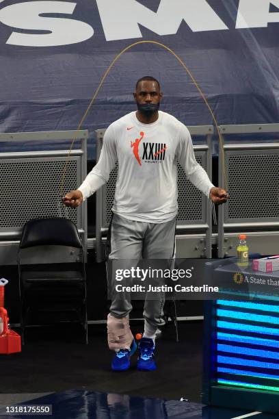 LeBron James of the Los Angeles Lakers warms up on the sidelines in the game against the Indiana Pacers during the second quarter at Bankers Life...