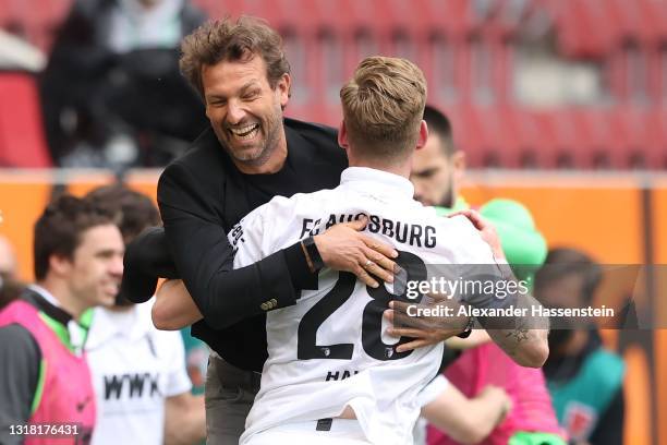 Markus Weinzierl, Head Coach of FC Augsburg celebrates victory with Andre Hahn of FC Augsburg following the Bundesliga match between FC Augsburg and...