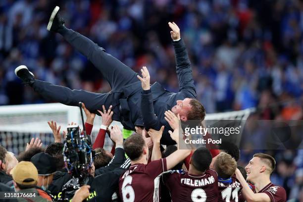 Players of Leicester City throw Brendan Rodgers, Manager of Leicester City in the air after victory in The Emirates FA Cup Final match between...