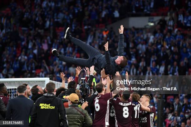 Players of Leicester City throw Brendan Rodgers, Manager of Leicester City in the air after victory in The Emirates FA Cup Final match between...