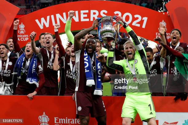 Kasper Schmeichel and Wes Morgan of Leicester City lift the Emirates FA Cup Trophy in celebration with team mates following The Emirates FA Cup Final...