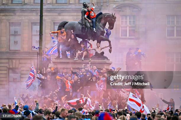 Rangers fans celebrate winning the Scottish Premiership title at George Square on May 15, 2021 in Glasgow, Scotland. Rangers have won their first...