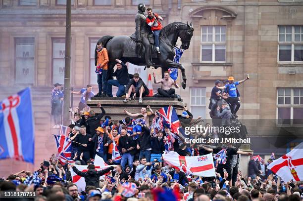 Rangers fans celebrate winning the Scottish Premiership title at George Square on May 15, 2021 in Glasgow, Scotland. Rangers have won their first...