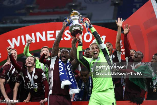 Kasper Schmeichel and Wes Morgan of Leicester City lift the Emirates FA Cup Trophy in celebration with team mates following The Emirates FA Cup Final...