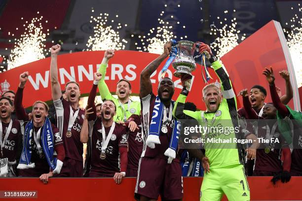 Kasper Schmeichel and Wes Morgan of Leicester City lift the Emirates FA Cup Trophy in celebration with team mates following The Emirates FA Cup Final...