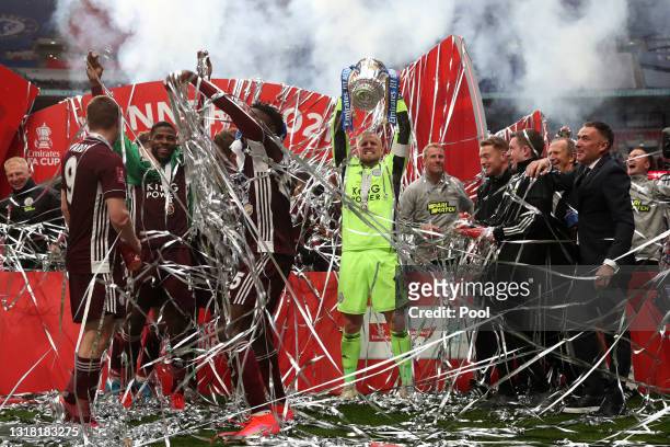 Kasper Schmeichel of Leicester City lifts the Emirates FA Cup Trophy in celebration with team mates following The Emirates FA Cup Final match between...
