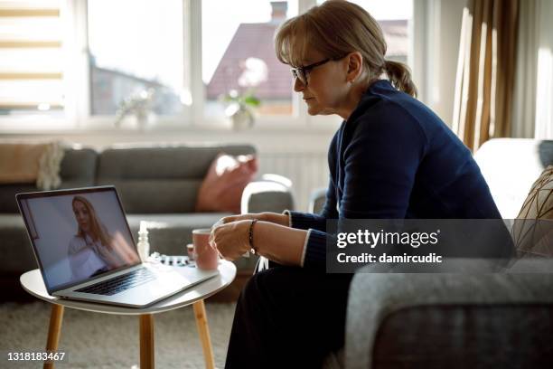 hogere vrouw die videogesprek met haar arts heeft - screening of ifc films the tribes of palos verdes stockfoto's en -beelden