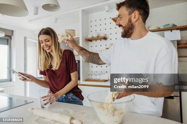 couple preparing dough - making pancakes stock pictures, royalty-free photos & images