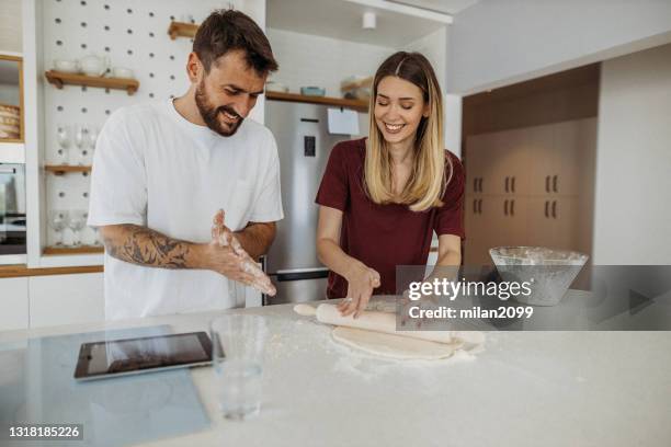 couple preparing dough - making pancakes stock pictures, royalty-free photos & images