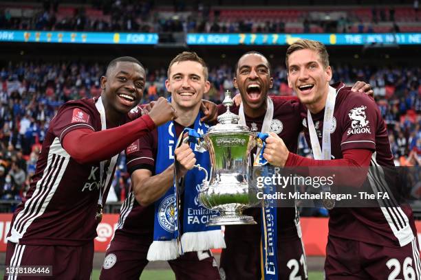 Nampalys Mendy, Timothy Castagne, Ricardo Pereira and Dennis Praet of Leicester City celebrate with the trophy following victory during The Emirates...