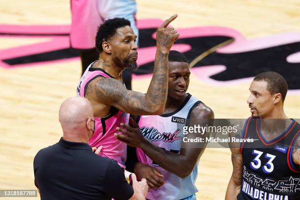 Udonis Haslem of the Miami Heat is held back by Kendrick Nunn and team security after a scuffle with Dwight Howard of the Philadelphia 76ers during...