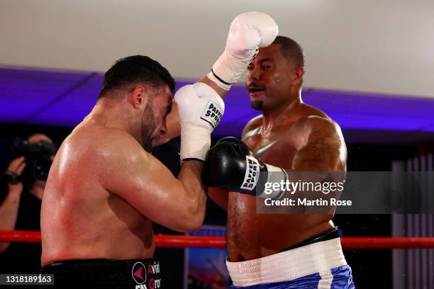 Mahmoud Charr of Germany exchanges punches with Christopher Lovejoy of United States during their WBA heavyweight fight at Sport Studio Baaden on May...