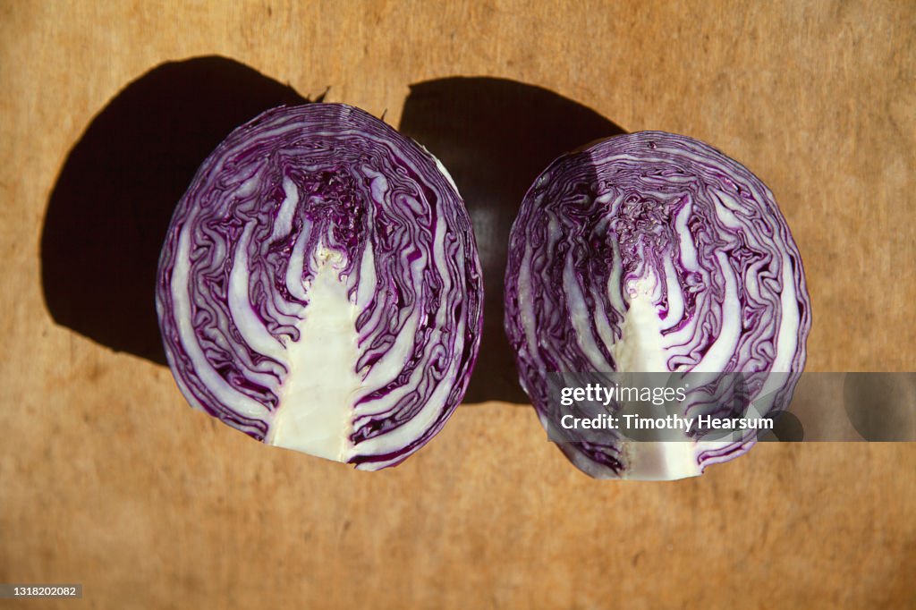 Close-up of red cabbage halves on a wooden board