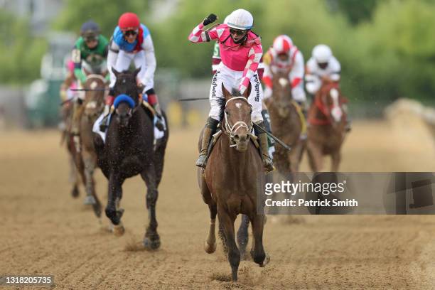 Jockey Flavien Prat riding Rombauer celebrates as he wins the 146th Running of the Preakness Stakes at Pimlico Race Course on May 15, 2021 in...