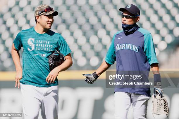 Yusei Kikuchi and Ichiro Suzuki of the Seattle Mariners talk before the game against the Cleveland Indians at T-Mobile Park on May 15, 2021 in...