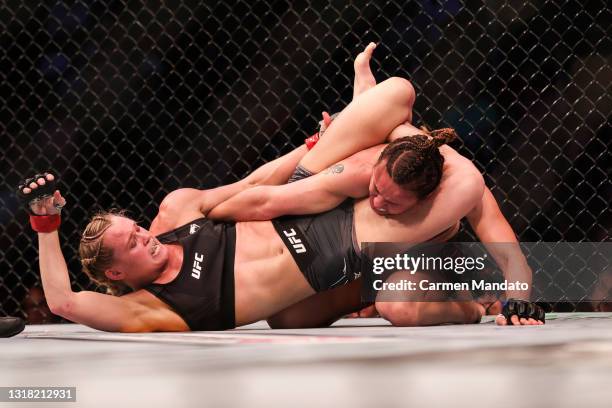 Andrea Lee applies pressure to the arm of Antonina Shevchenko during their Women's Flyweight Bout of UFC 262 at Toyota Center on May 15, 2021 in...