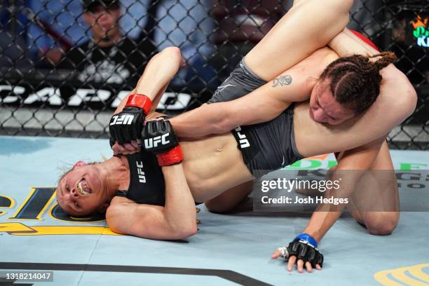 Andrea Lee attempts to submit Antonina Shevchenko of Kyrgyzstan in their women's flyweight bout during the UFC 262 event at Toyota Center on May 15,...