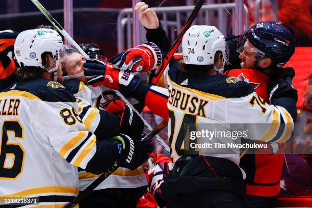 Anthony Mantha of the Washington Capitals punches Jeremy Lauzon of the Boston Bruins during the second period during Game One of the First Round of...