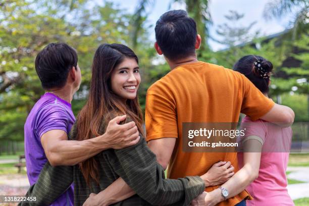 group of friends walking together - group arm in arm stock pictures, royalty-free photos & images