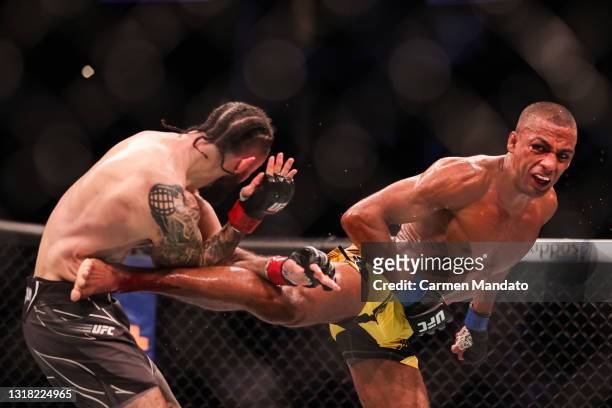 Edson Barboza kicks Shane Burgos during their featherweight bout of UFC 262 at Toyota Center on May 15, 2021 in Houston, Texas.
