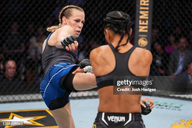 Katlyn Chookagian kicks Viviane Araujo of Brazil in their women's flyweight bout during the UFC 262 event at Toyota Center on May 15, 2021 in...