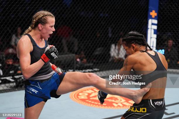 Katlyn Chookagian kicks Viviane Araujo of Brazil in their women's flyweight bout during the UFC 262 event at Toyota Center on May 15, 2021 in...