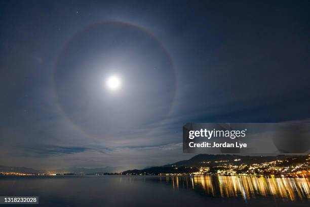 lunar halo on zurich sea - halo symbol stock pictures, royalty-free photos & images