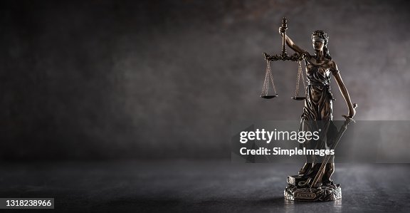 Blind justice symbol on a metallic statue on a dark background. Blind justice symbol on a metallic statue on a dark background.