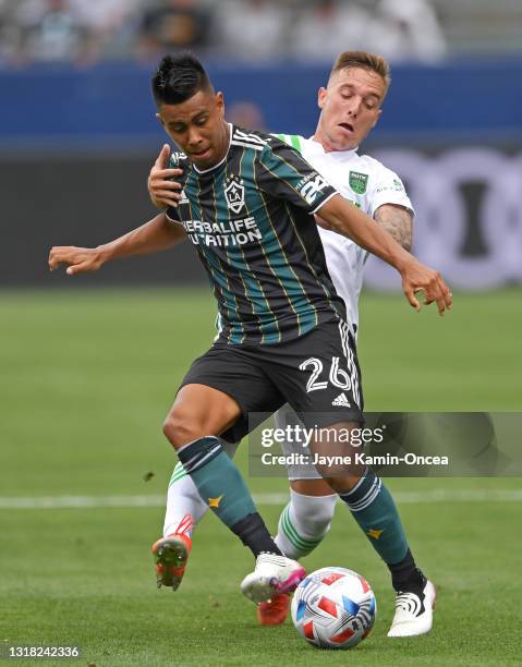 Zan Kolmanic of Austin FC and Efrain Alvarez of the Los Angeles Galaxy battle for the ball in the game at Dignity Health Sports Park on May 15, 2021...