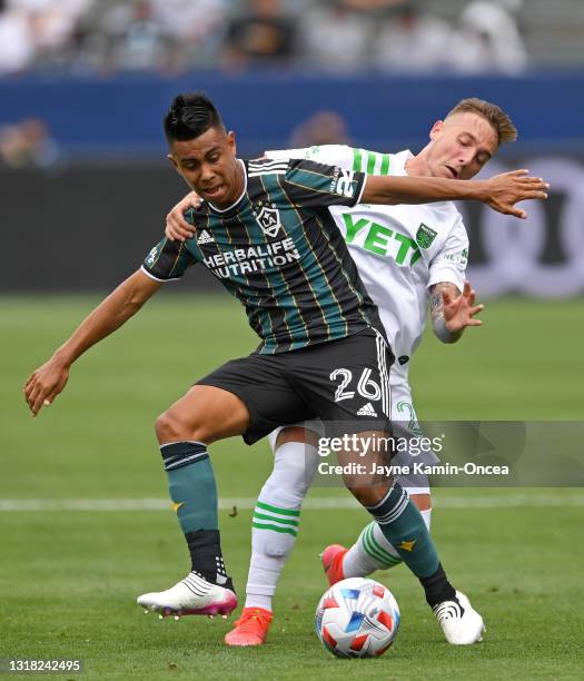 Zan Kolmanic of Austin FC and Efrain Alvarez of the Los Angeles Galaxy battle for the ball in the game at Dignity Health Sports Park on May 15, 2021...