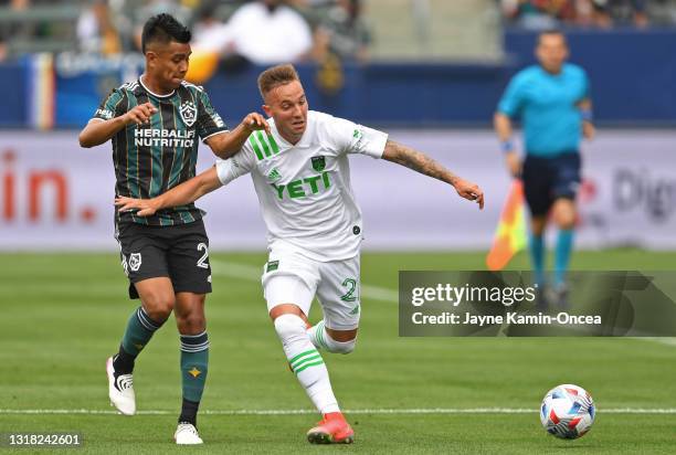 Zan Kolmanic of Austin FC and Efrain Alvarez of the Los Angeles Galaxy battle for the ball in the game at Dignity Health Sports Park on May 15, 2021...