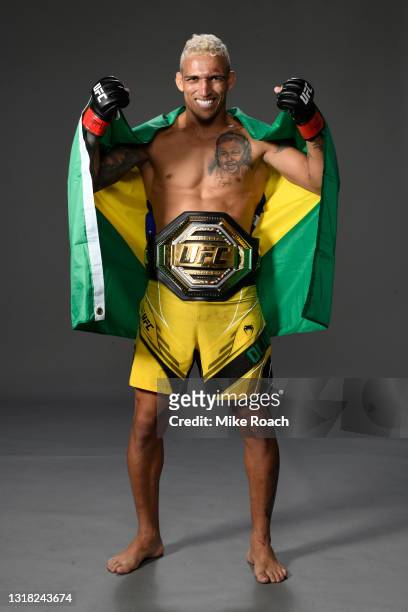 Charles Oliveira of Brazil poses for a post fight portrait with the UFC lightweight championship belt backstage during the UFC 262 event at Toyota...